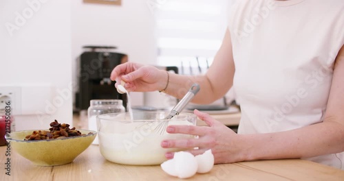 Home cooking. Kneading dough. Female chef hand adding measuring ingredient salt sugar in glass bowl with flour mixing whisk pastry mass.