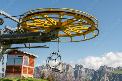 Dolomites, Italy. Chairlift and cableway infrastructure with dramatic Alpine mountain landscape