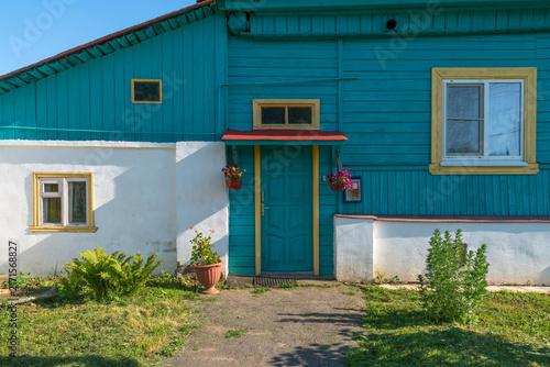 The front door with a canopy of a traditional Russian wooden house on a sunny summer day, Suzdal, Vladimir Oblast, Russia