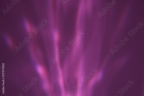 Abstract dark purple background with diagonal neon pink light refractions and soft wavy shadow overlays. Ideal textured backdrop for modern aesthetic design projects.