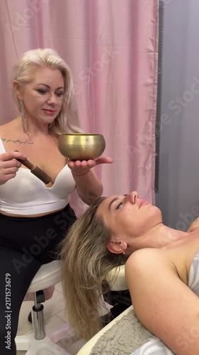 Spiritual Sound Healing Therapy Using Singing Bowl for Relaxation and Wellness. Vertical video.