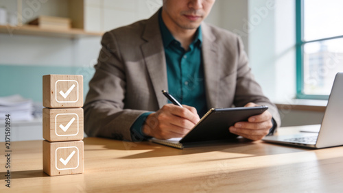 Business Task Completion Concept with Professional Man Using Tablet and Wooden Checklist Blocks, Productivity, Planning, Project Management and Success