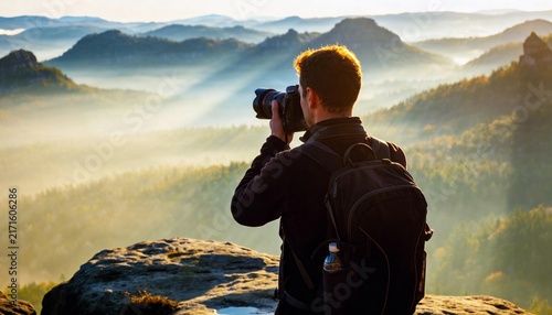 photographer taking pictures of mountains