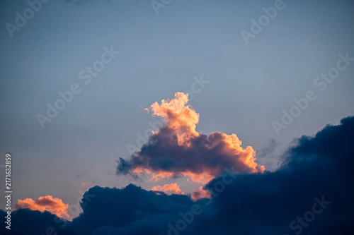 Glowing Orange Sunset Cloud Above Dark Storm Clouds