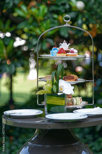 Outdoor Afternoon Tea Stand with Desserts and Savory Snacks in Garden