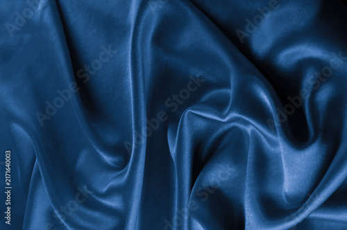Blue satin fabric texture with soft folds and highlights