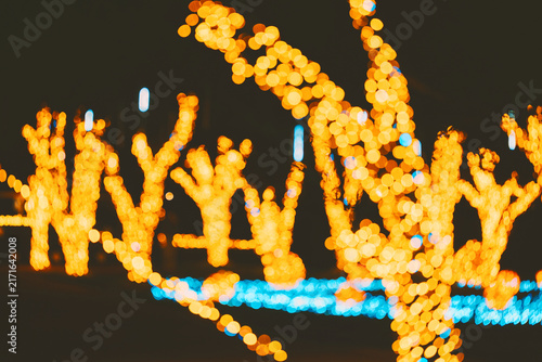 Konstfotografi Bright orange yellow bokeh lights shine on dark night creating a blurred festive decoration background