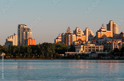 Canvastavla Modern residential architecture along Obolonska Embankment in Kyiv, Ukraine, illuminated by warm evening sunlight across the Dnipro River