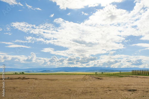 Canvastavla Expansive rural landscape under a big cloudy sky