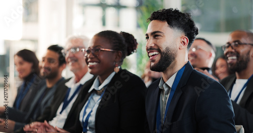 Presentation, crowd or man at seminar with training, attention or budget review at conference. Happy, finance advisor or audience with learning, target coaching or engagement at corporate event.