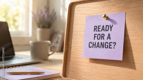 Purple sticky note with text ready for a change pinned to wooden board on office table background.