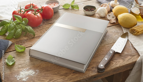 A recipe book surrounded by fresh ingredients and kitchen utensils.