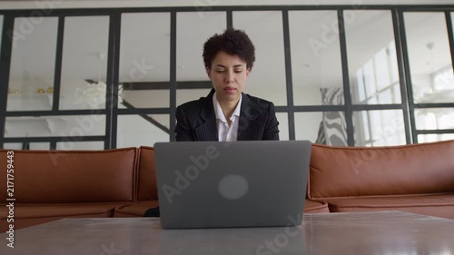 Businesswoman Reading Laptop Screen in Office