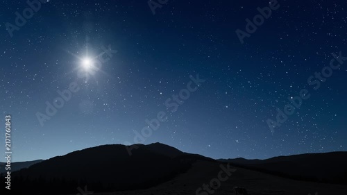 Glowing Christmas star above a peaceful mountain landscape with night sky
