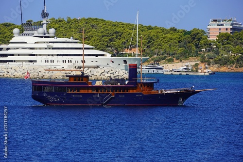 A blue luxury yacht designed to look old, near the coast of Vouliagmeni, in Athens, Greece