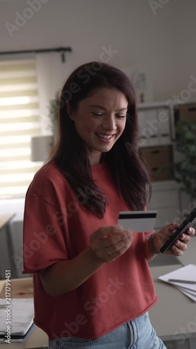 Woman making online purchase with credit card and smartphone