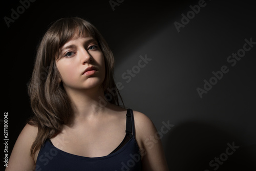 Beautiful teenage girl posing for beauty portrait on dark background