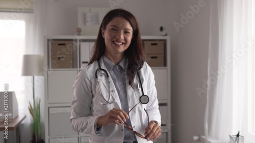 Professional female doctor smiling in her medical office