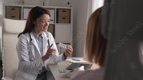 Female doctor prescribing medicine to patient during medical appointment