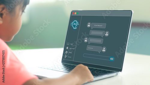 Over the shoulder view of Asian child using laptop with AI chatbot application UI overlay, chatting with virtual assistant for interactive e-learning and AI education concept.