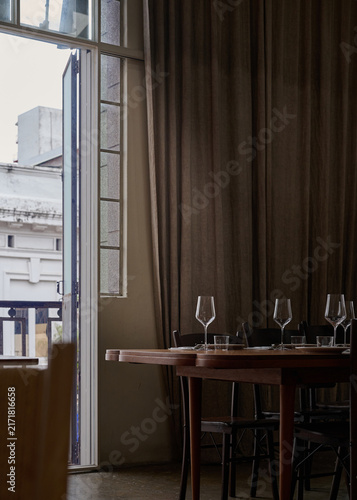 Heritage Style Restaurant Interior with Wooden Dining Table and Window