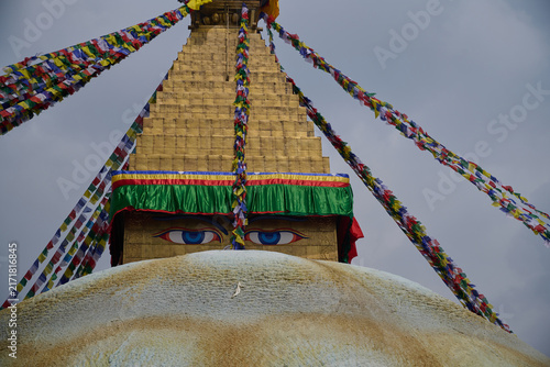 Quadro su tela Buddha eyes on Boudhanath Stupa with colorful prayer flags in Kathmandu, Nepal