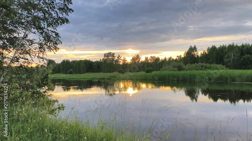 Scenic forest river at sunset with colorful cloud movement and reflective water timelapse