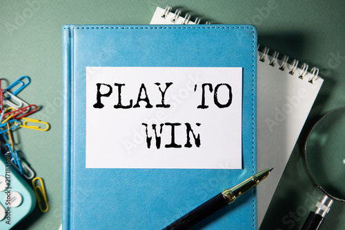 Fotografie PLAY TO WIN text on paper