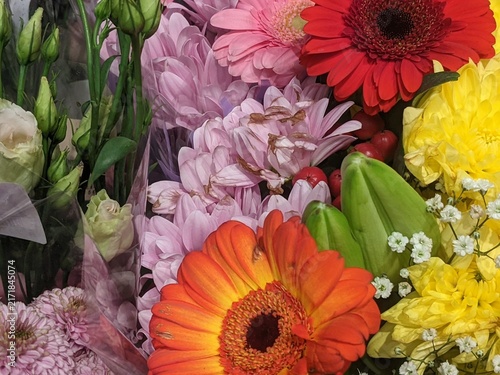 Vibrant autumn bouquet with orange gerbera daisy, pink chrysanthemums, orange rose and red hypericum berries