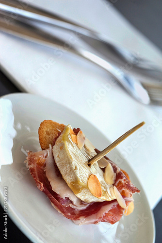 Pintxos on white plate in a Spanish bistro