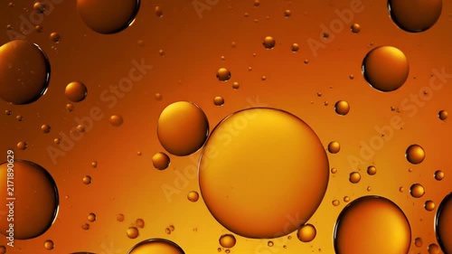 Oil Drops Floating in Water with Warm Amber Light and Subtle Movement