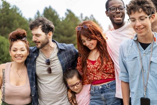 Multicultural people embracing each other outdoors, symbol of belonging, human connection and inclusion