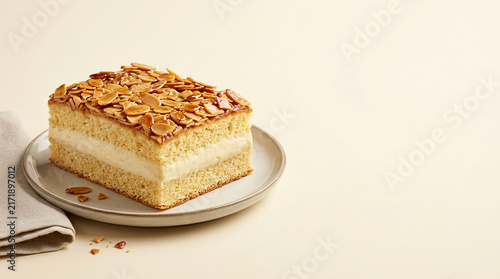 Delicious slice of golden almond flan cake with creamy vanilla filling, elegantly presented on a ceramic plate, perfect for a delightful dessert or a sweet afternoon treat