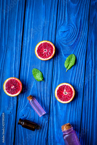 organic cosmetic with citrus on blue background top view