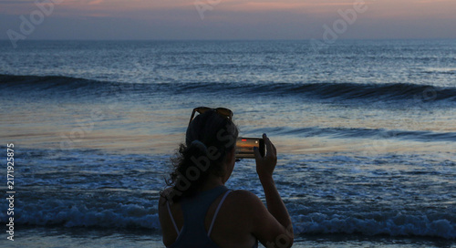 Women Taking a Picture of Sunrise on the Beach in Corolla North Carolina