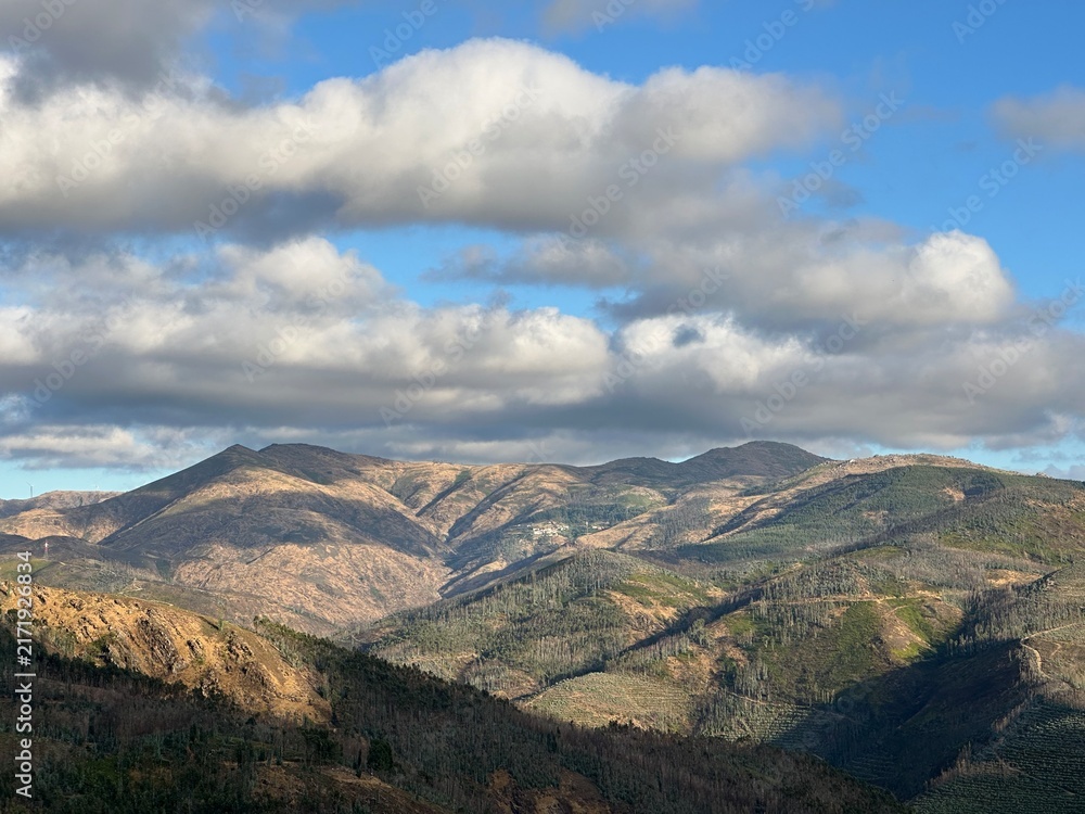 Fototapeta premium Mountain range of Arouca geopark under cloudy blue sky, Canelas, Aveiro, Portugal, July 2025
