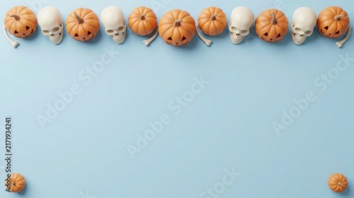 Halloween arrangement of pumpkins and skulls on a light blue background with copy space