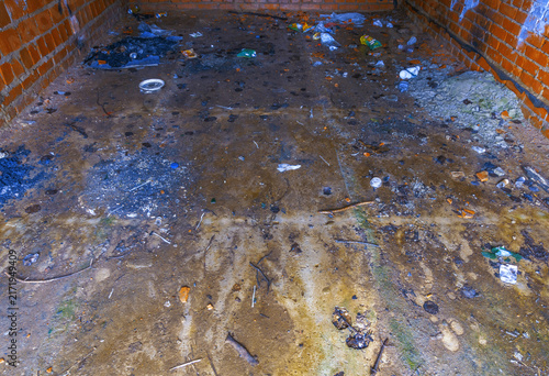 Canvas Print Interior of small brick garage showing wet muddy concrete floor stained with oil