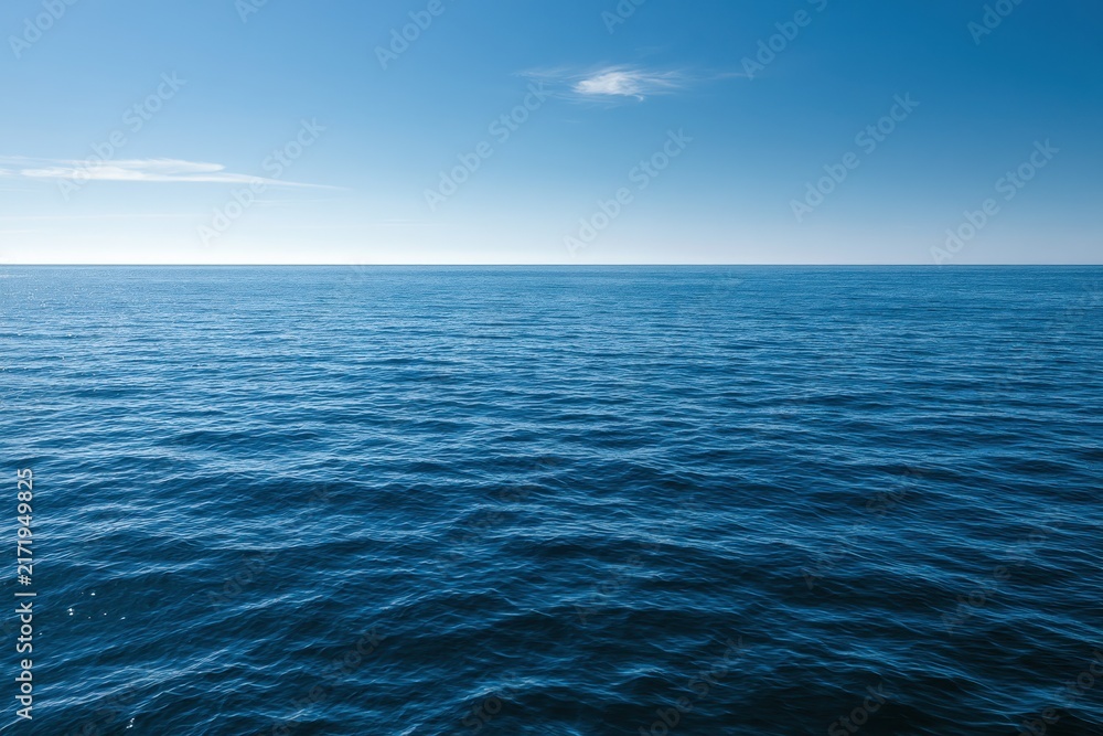 Fototapeta premium Azure water and blue sky horizon: peaceful seascape with gentle waves
