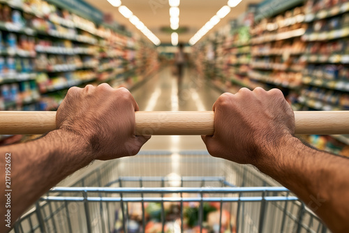 Hands Gripping Wooden Shopping Cart Handle
