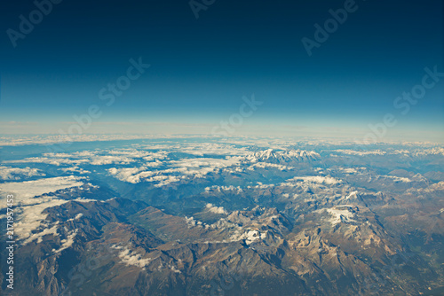 Wide Panoramic View of Mountain Ranges Interspersed With Drifting Clouds and Distant Snowy Peak