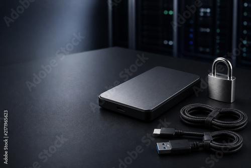 Fototapeta Secure offline data backup with external drive and padlock