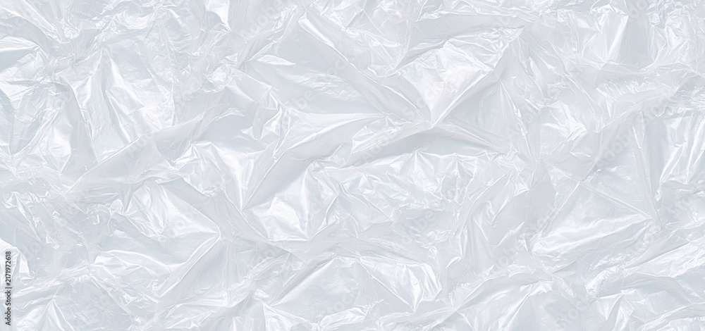 Obraz premium Translucent plastic film with wrinkled texture in soft white tones, ideal for modern packaging backgrounds.