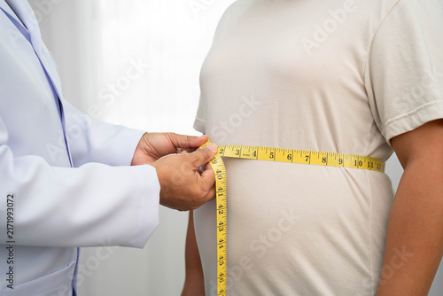 Bild auf Leinwand Asian woman with fat belly big size overweight and obesity with measure tape