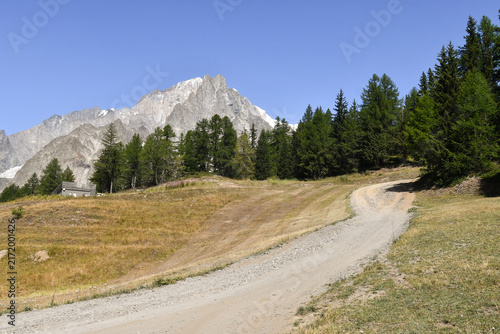 Obraz na płótnie Winding dirt road and hiking trail heading towards Mont Chetif peak in Mont Blan