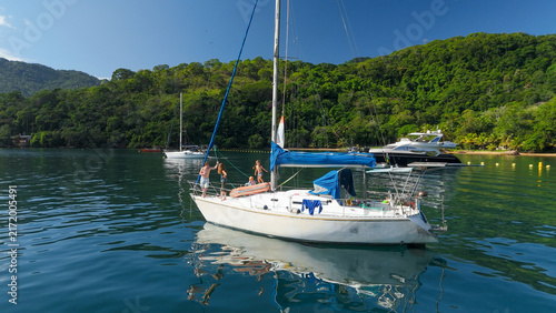 Calm green lagoon with sailing boats on the island of Ilha Grande, Brazil