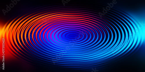 Radiant blue and orange ripple waves forming abstract circular design for backdrop use.
