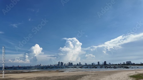 City skyline and fishing boats across the bay under dramatically large cumulus clouds, Da Nang, Viet Nam