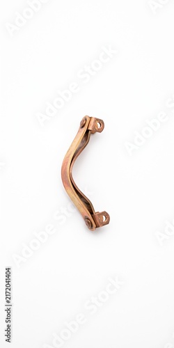 Macro of a beryllium copper wireline centralizer bow spring. Downhole measurement and logging tool hardware with raw industrial finish isolated on white.