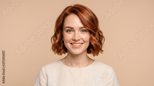 Smiling Woman with Copper Red Wavy Bob Hair and Natural Makeup Portrait